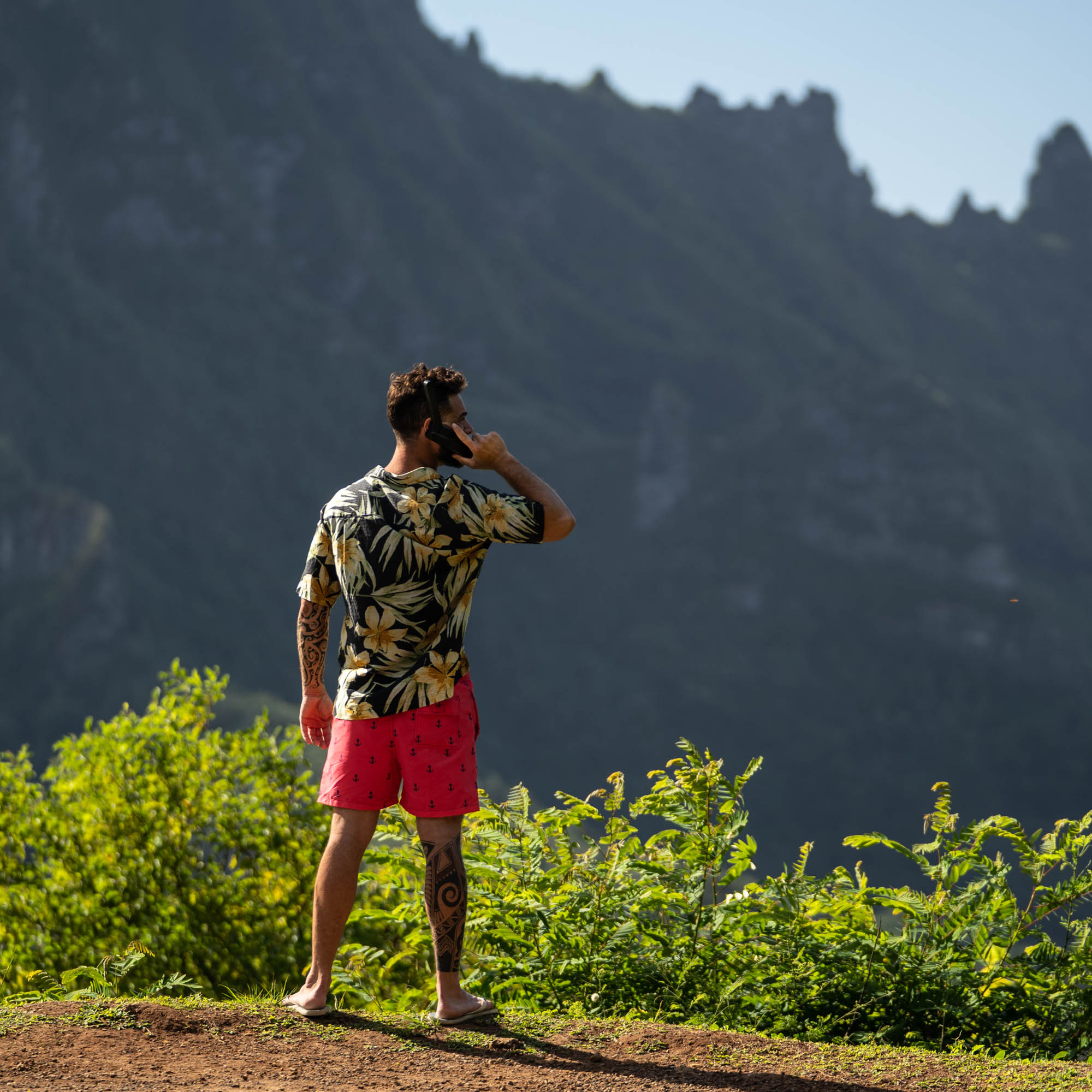 Person using a satellite phone in remote mountains
